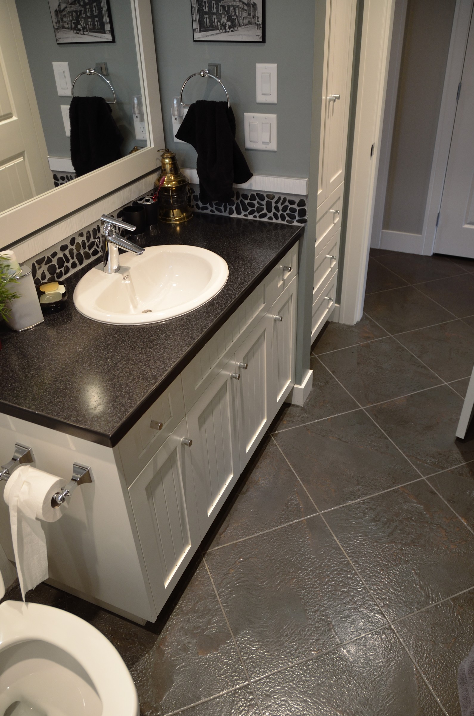 Modern bathroom with grey StoneCraft flooring and white shaker vanity