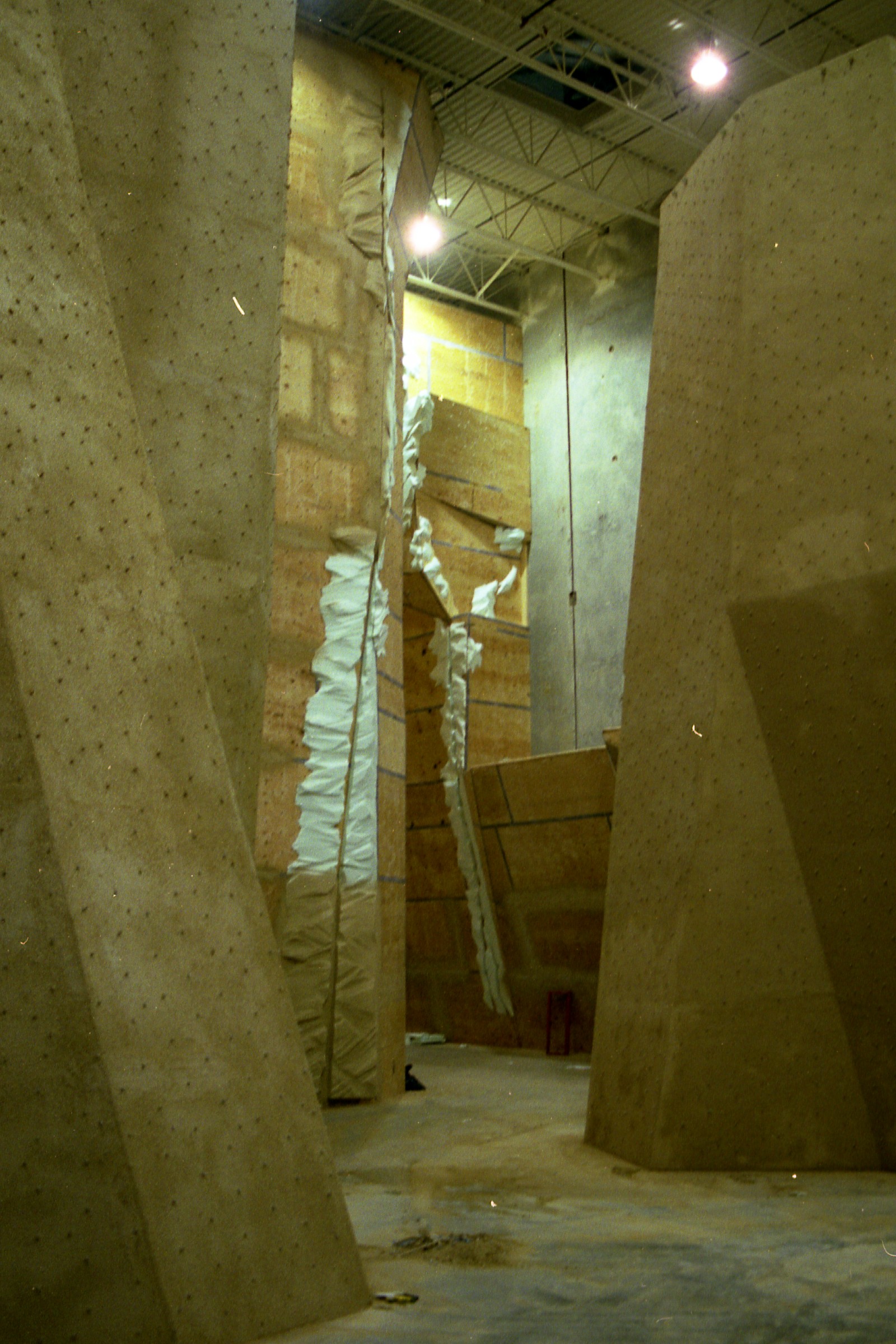 StoneCraft climbing surface applied over plywood and steel substrates in large gym