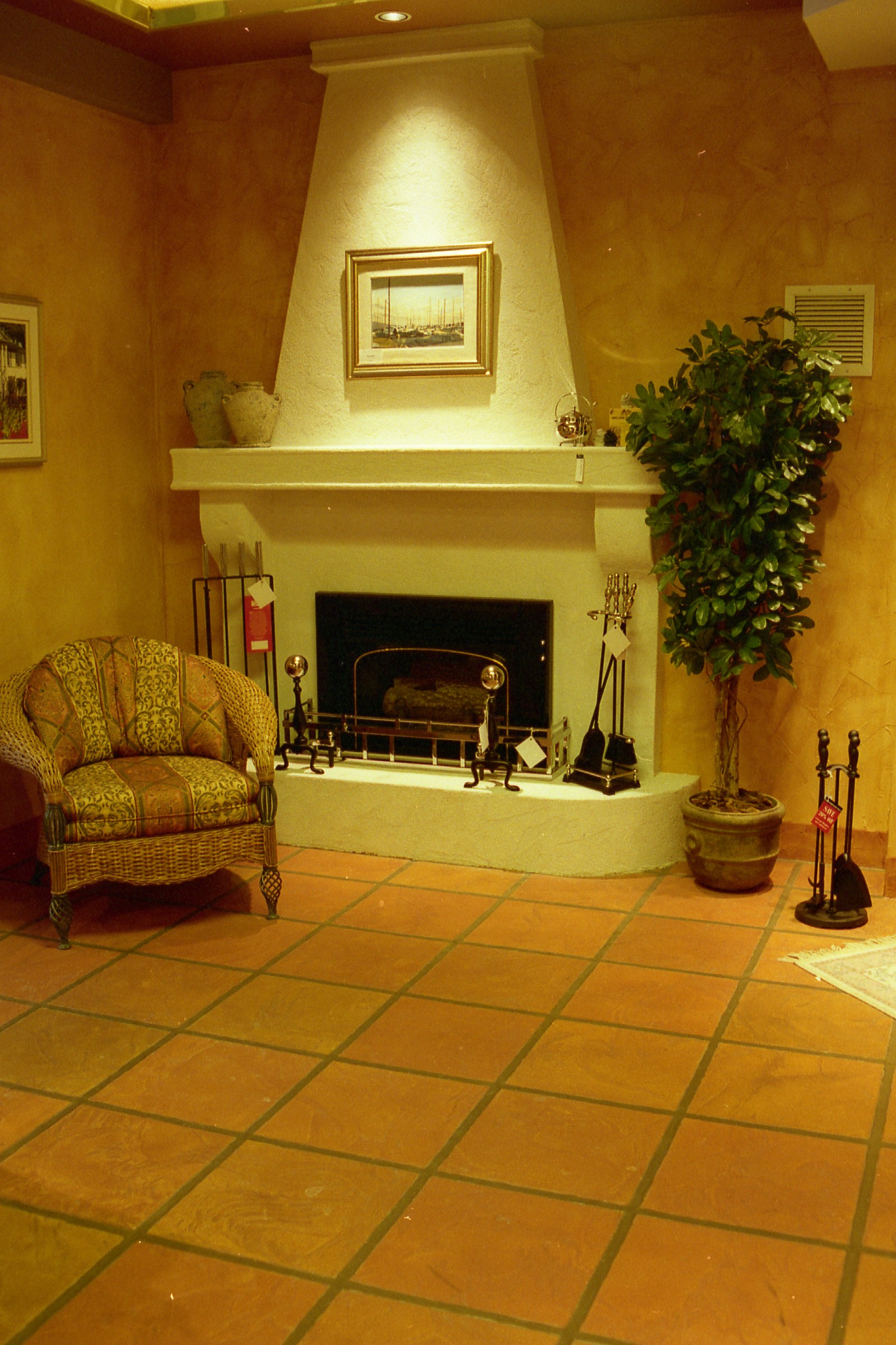 Tuscan-style StoneCraft full fireplace surround with terracotta floor