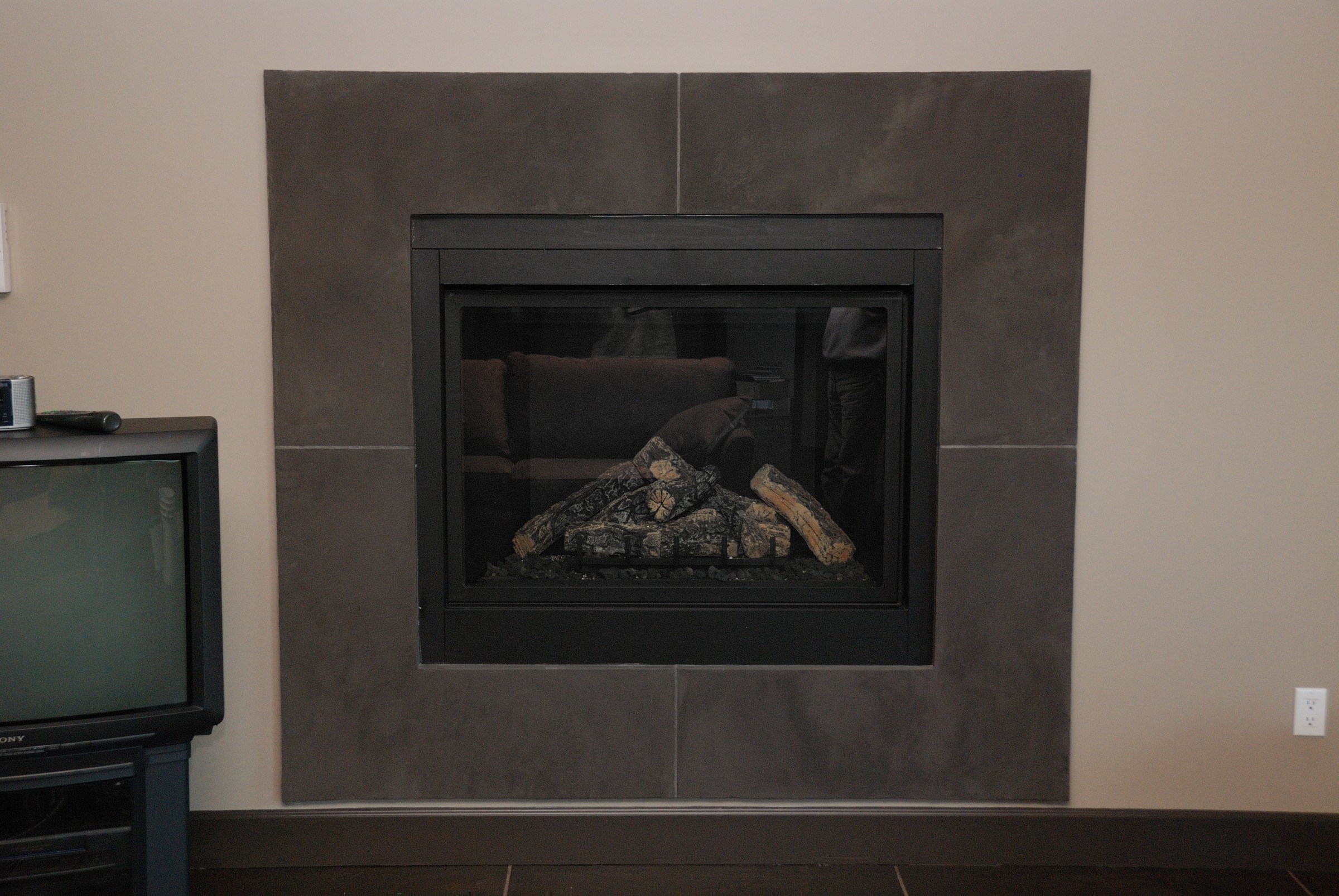Modern minimalist StoneCraft fireplace surround with clean grey finish