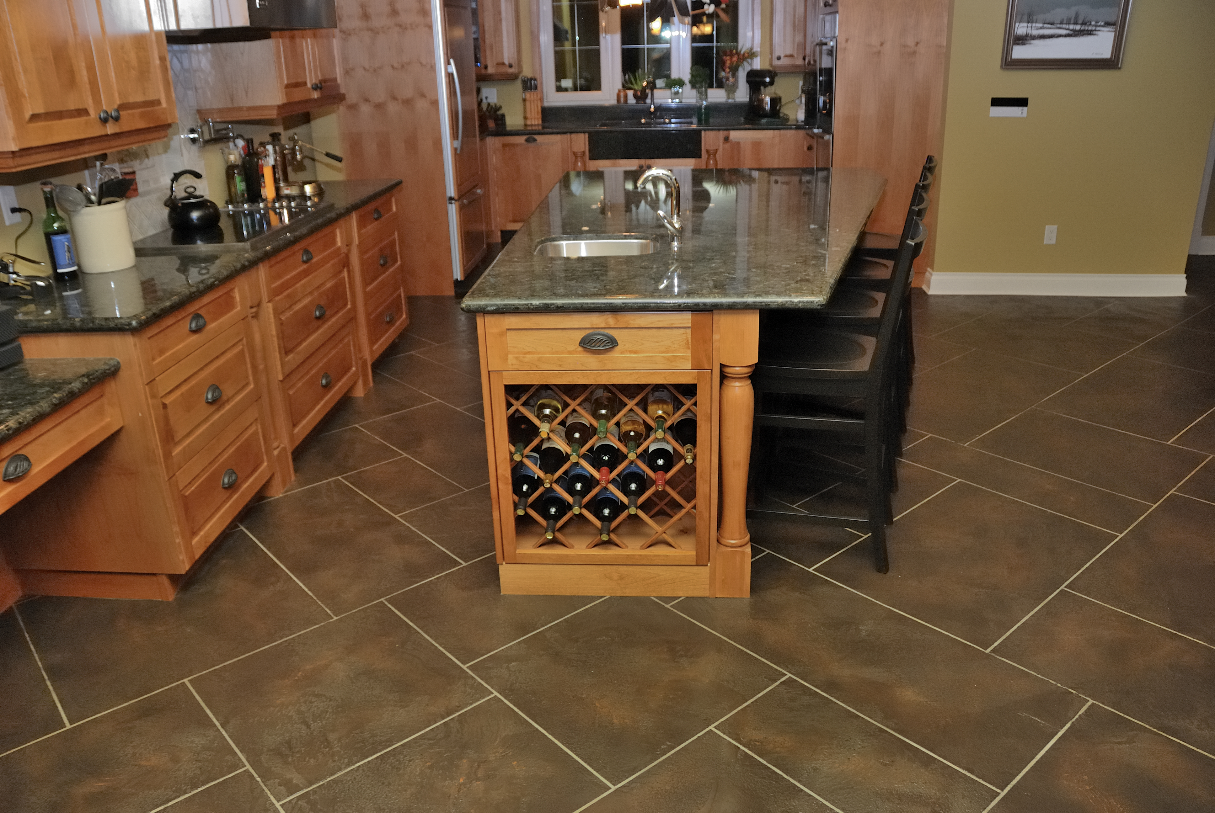 Country kitchen with dark brown StoneCraft slate flooring and wine island