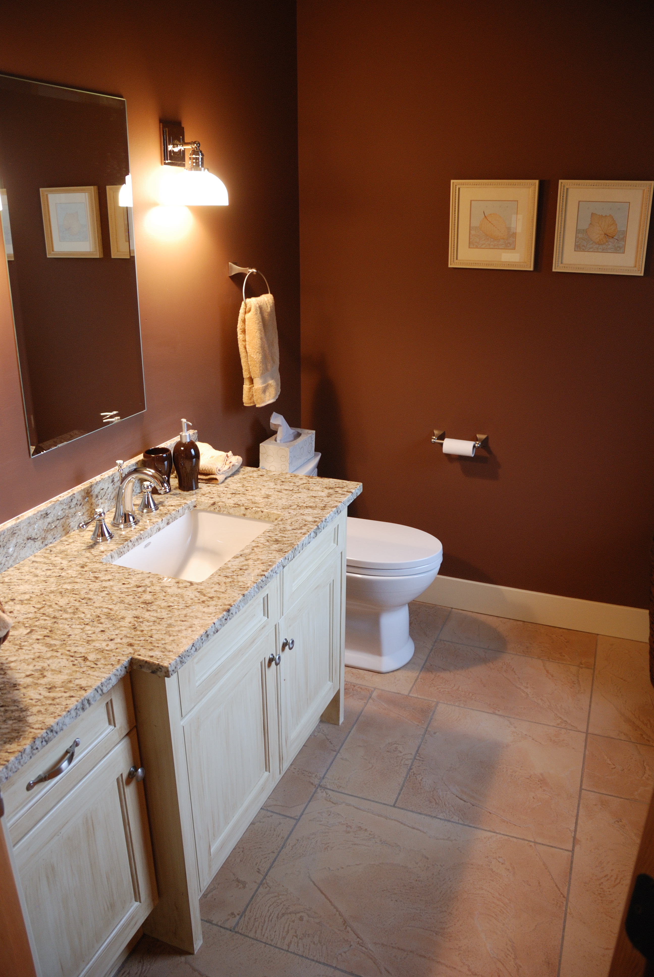 StoneCraft bathroom floor in warm tones with vanity and fixtures