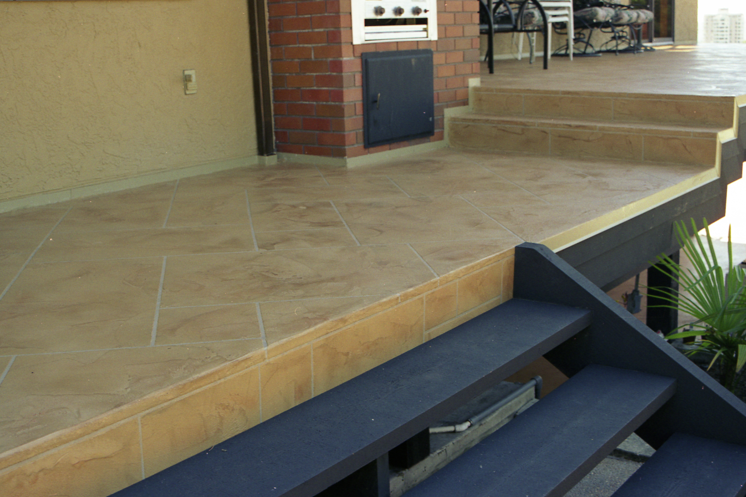 Elevated patio with sandstone StoneCraft surfacing and barbecue area