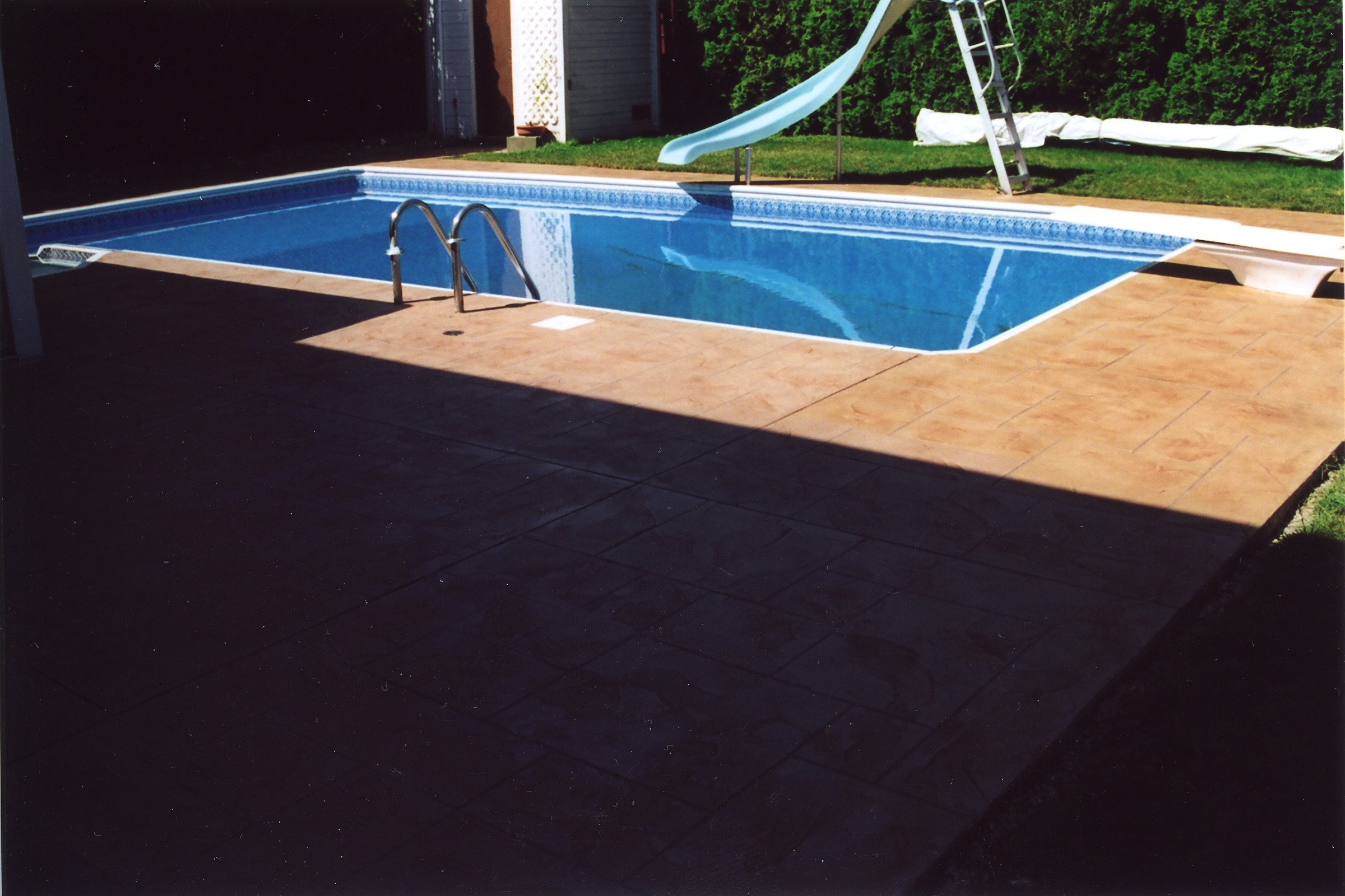 Custom colour StoneCraft pool deck matched to home exterior